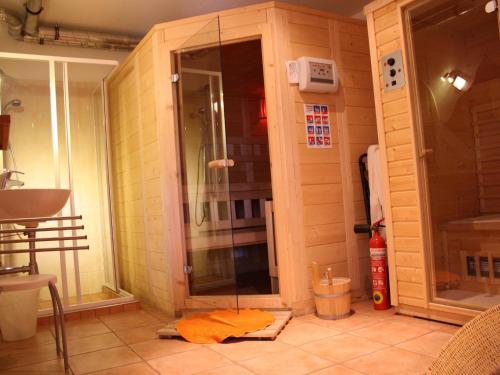 a shower with a glass door in a room at Spacious Chalet in Piesendorf with Sauna in Dürnberg