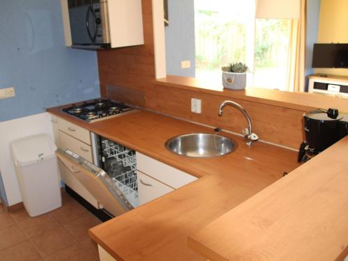 a kitchen with a sink and a counter top at Cozy family Bunglow in Zevenhuizen in Zevenhuizen