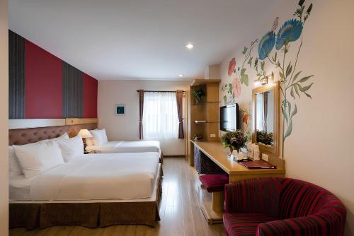 a hotel room with a bed and a chair at Asian Ruby Hotel & Spa - 122F Bui Thi Xuân Street in Ho Chi Minh City