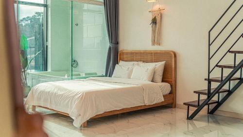 a bedroom with a bed and a glass shower at Majoong Pool Villa Pension in Gyeongju
