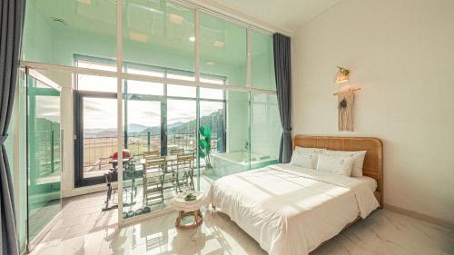 a bedroom with a bed and a large window at Majoong Pool Villa Pension in Gyeongju