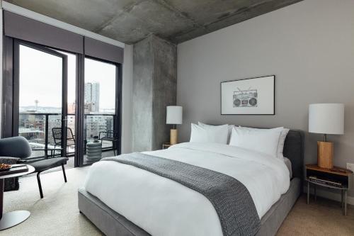 a bedroom with a large bed and a large window at Mint House Denver - Downtown Union Station in Denver