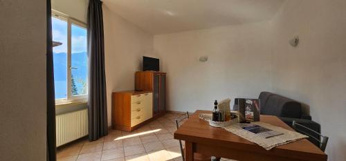 a living room with a table and a chair at Casa Guarnati Lake View Apartments in Malcesine