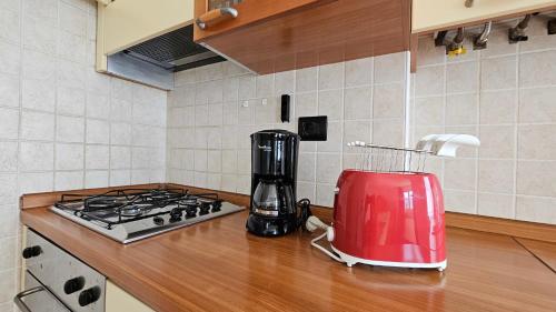 a kitchen counter with a red blender on a counter top at Casa Guarnati Lake View Apartments in Malcesine