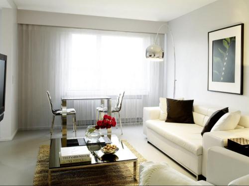 a living room with a white couch and a coffee table at VISIONAPARTMENTS Binzmühlestrasse 50 - contactless check-in in Zürich