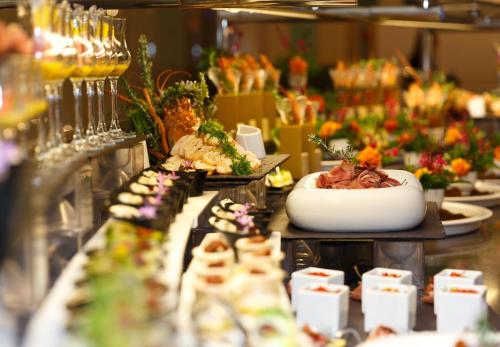 a buffet with plates of food on a table at Elysium Resort & Spa in Faliraki