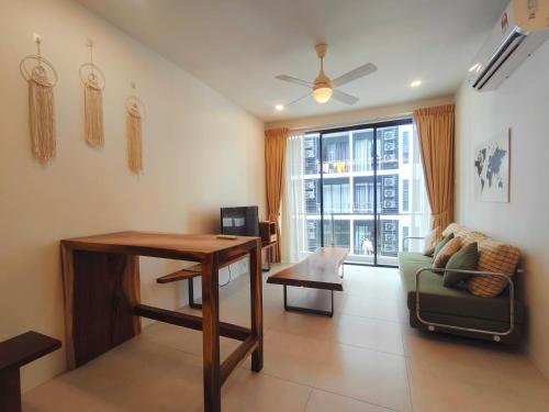 a living room with a table and a couch at SoulHealingPlace Galacity 2BR 3Bed Apartment in Kuching