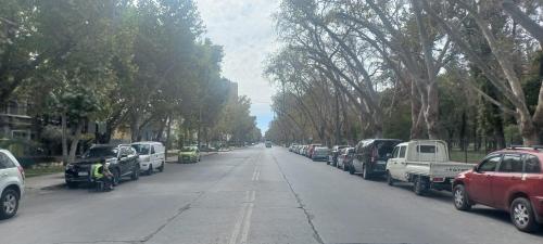 a street with cars parked on the side of the road at Movistar Apart Santiago in Santiago