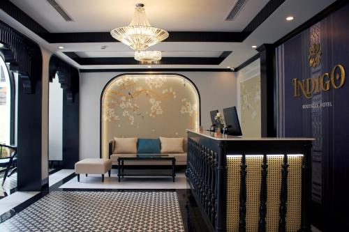 a living room with a couch and a chandelier at Indigo Boutique Hotel in Cao Bằng