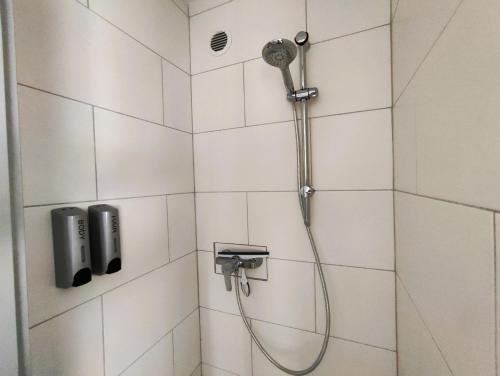 La salle de bains est pourvue d'une douche avec un pommeau de douche. dans l'établissement Ferienwohnung Heide 2, à Kalyves