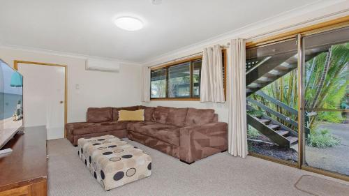 a living room with a couch and a staircase at Bayside Delight in North Haven
