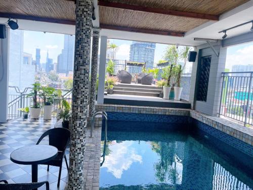 a swimming pool on the balcony of a house at Aodai Inn Saigon in Ho Chi Minh City