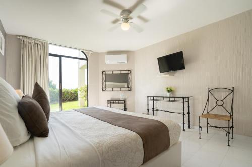a bedroom with a large bed and a tv on the wall at Hotel Master Club in Tequesquitengo