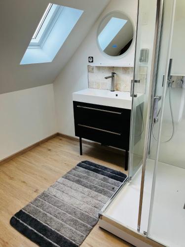 a bathroom with a sink and a mirror at Le gite de l’oppidum in Étrun
