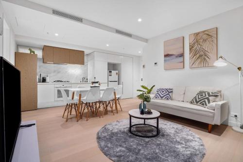 a living room with a couch and a table at Lv 60 Skyline 2B 2B 1CP in Heart of Melbourne in Melbourne