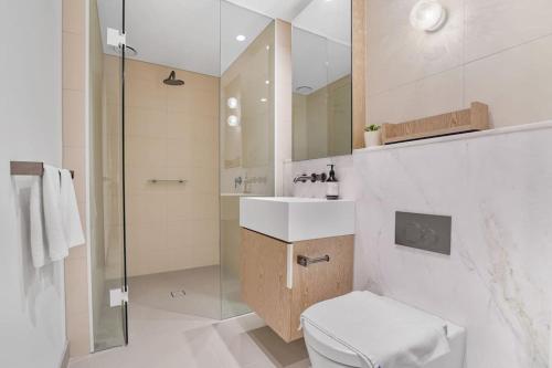 a bathroom with a shower and a toilet and a sink at Lv 60 Skyline 2B 2B 1CP in Heart of Melbourne in Melbourne