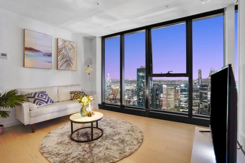 a living room with a couch and a table at Lv 60 Skyline 2B 2B 1CP in Heart of Melbourne in Melbourne