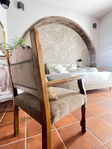 a bedroom with a bed and a chair in a room at Lucilla’s Suite San Pietro station in Rome
