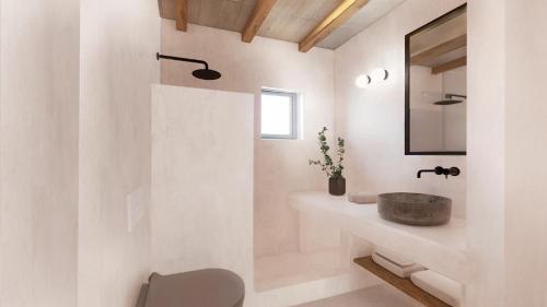 a bathroom with a sink and a mirror at Seascape, Suite 3 with sea view in Áno Meriá