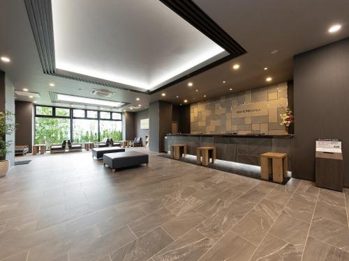 a lobby of a hospital with a waiting room at Hotel Route Inn Kyoto Kameoka Ekimae in Kameoka