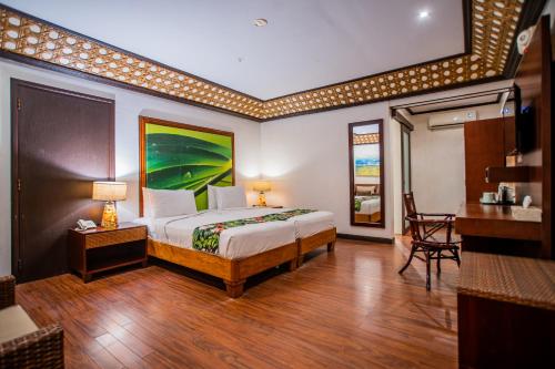 a hotel room with a bed and a desk and a desk at Club Agutaya in San Vicente