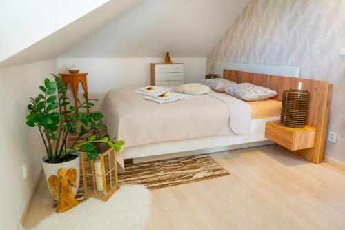 a bedroom with a bed in a attic at Apartmán Naděje in Luhačovice