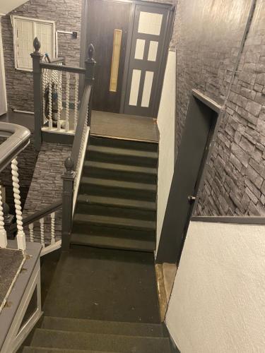 a stairway with a door and a stair case at The Drop inn in Park Gate