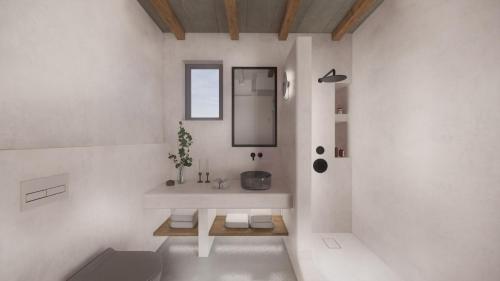 a white bathroom with a sink and a mirror at Seascape, apartment 5 with sea view in Áno Meriá