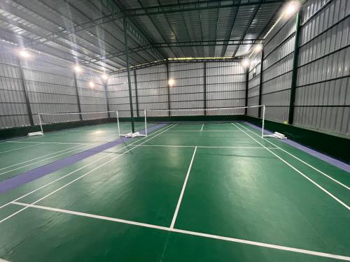an indoor tennis court with lights on it at AruBhi Cottage in Dehradun