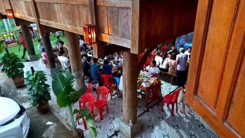 a group of people sitting at tables in a restaurant at Puluong Bao Gia Homestay in Hương Bá Thước