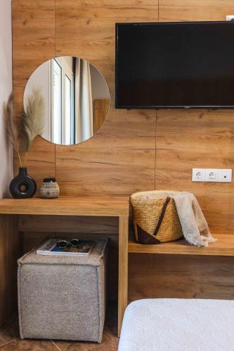 a room with a television on a wooden wall at Skiathos Avaton Garden, Philian Hotels and Resorts in Skiathos Town