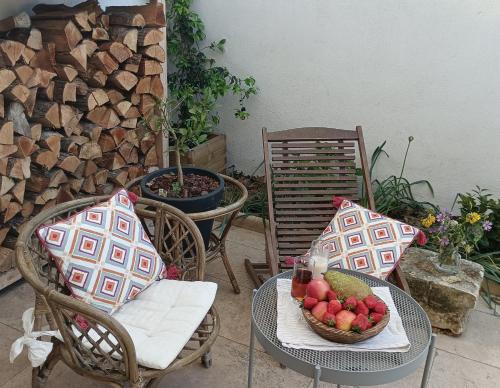 - deux chaises et une table avec un bol de fruits dans l'établissement Maison Arelate, à Arles