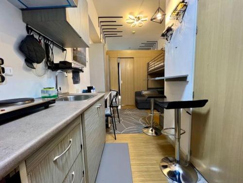 a kitchen with a sink and a counter top at H&H at Grace Residences in Manila