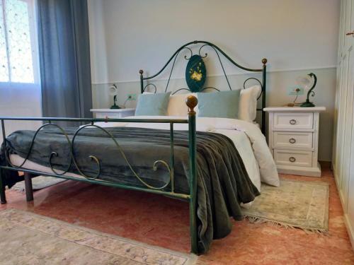 a bedroom with a bed with a metal frame at SOFIA in Venice