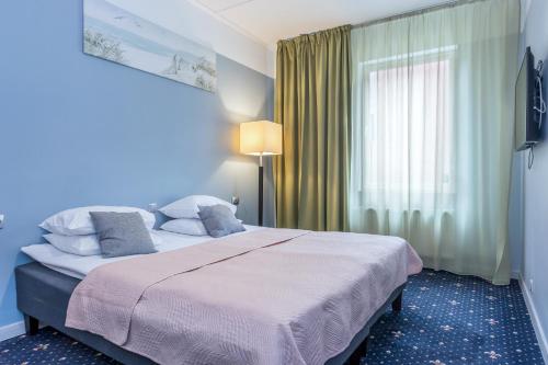 a bedroom with a large bed and a window at Bern Boutique by Rikas Hotels in Tallinn