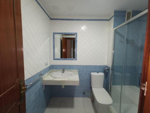 a bathroom with a sink and a toilet and a mirror at MRZ RENTALS JEREZ in Jerez de la Frontera