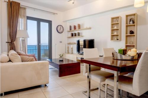 a living room with a table and a couch at Filia Home in Agios Nikolaos