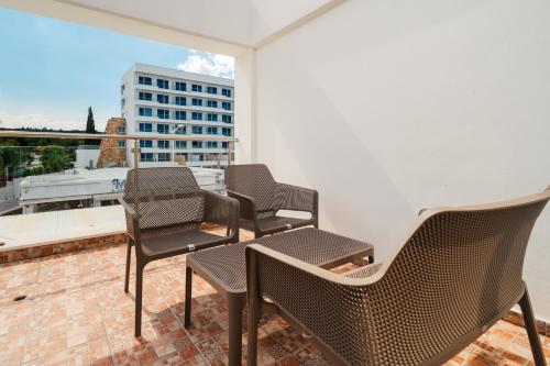 a group of chairs sitting on top of a balcony at Seafront Protaras Apartments in Protaras