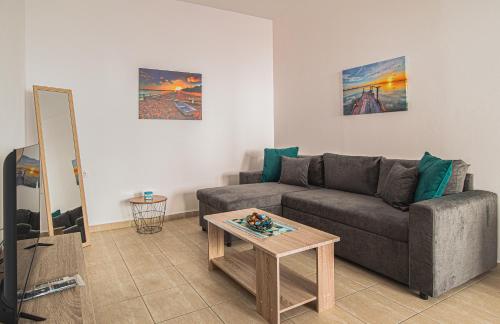 a living room with a couch and a table at Basiliki's Apartments in Archangelos
