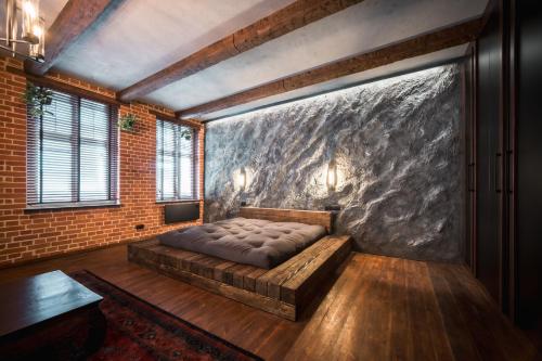 a bedroom with a bed in a brick wall at Św. Antoniego in Wrocław