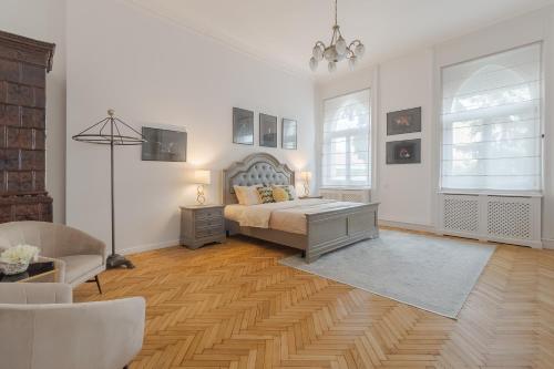 a bedroom with a bed and a couch and a chair at UNIQUE EXPERIENCE at Rimanóczy Palace Oradea in Oradea