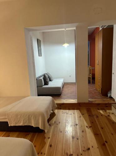 a bedroom with two beds and a couch in it at Themis Apartment in Kotor