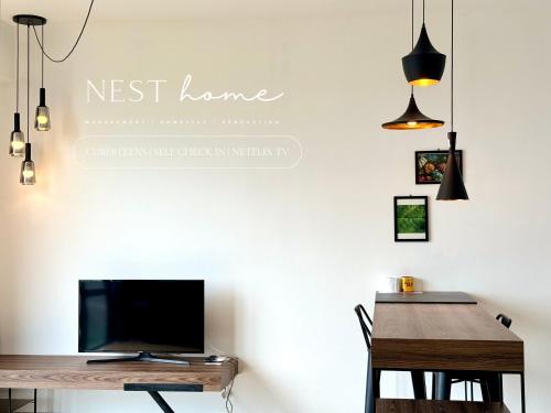 a living room with a desk and a tv and a table at Cube 8teens by Nest Home in Johor Bahru