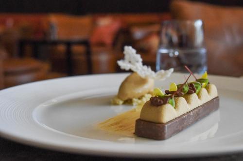 a dessert on a white plate on a table at AlpenGold Hotel Davos in Davos