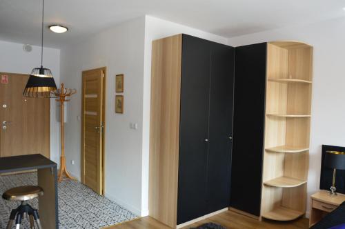 a room with black and wooden book shelves at Perla Gdańsk in Gdańsk