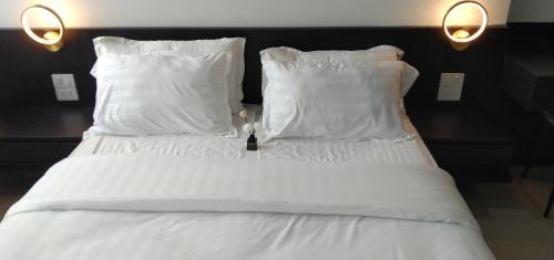 a bed with white sheets and pillows in a room at LOVE HOME-Luxury&chill Apart Hue city-2bed-5'Trang tien in Hue