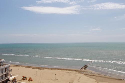 a view of the beach from the balcony of a building at Mare Fuori in Nettuno