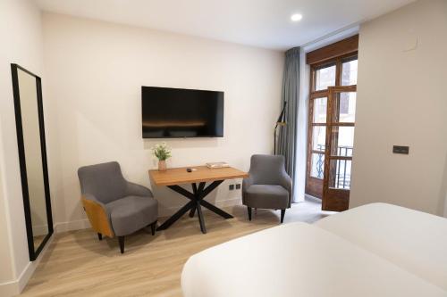 Televiisor ja/või meelelahutuskeskus majutusasutuses Prisma Suites