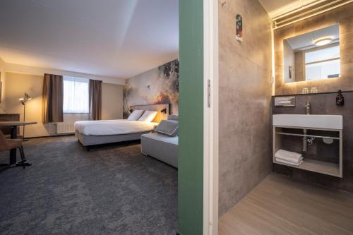 Postel nebo postele na pokoji v ubytování Fletcher Hotel Restaurant Rooland