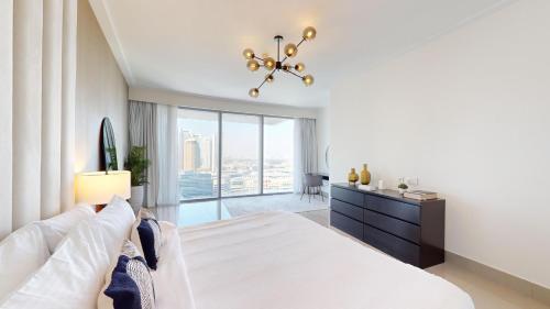 a bedroom with a bed and a large window at Primestay - 2BR Fountain View Opera Grand - Downtown in Dubai